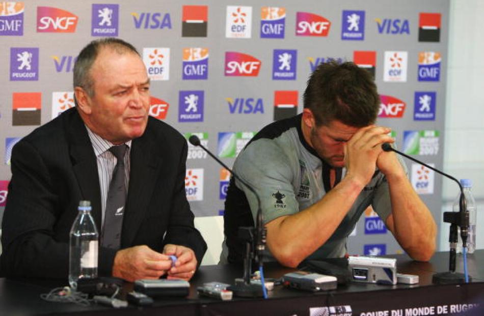The pain . . . McCaw and coach Graham Henry front the media after the loss to France in the 2007...