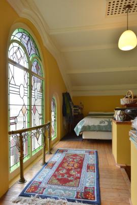 The brass railing from the church's shrine now sits in front of the windows on the mezzanine level.