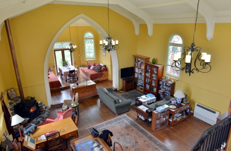 The owners enjoy the sense of space provided by the high ceilings. This view is from the...