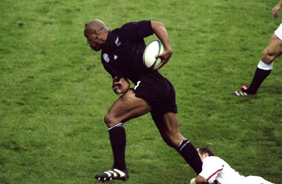 An English defender tries to cling on as Jonah Lomu powers his way to score one of his best ever...