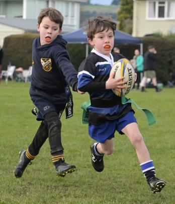 Elliott Grace, 6, of Kaikorai, gets away from Dunedin’s Abraham Thompson, 6.