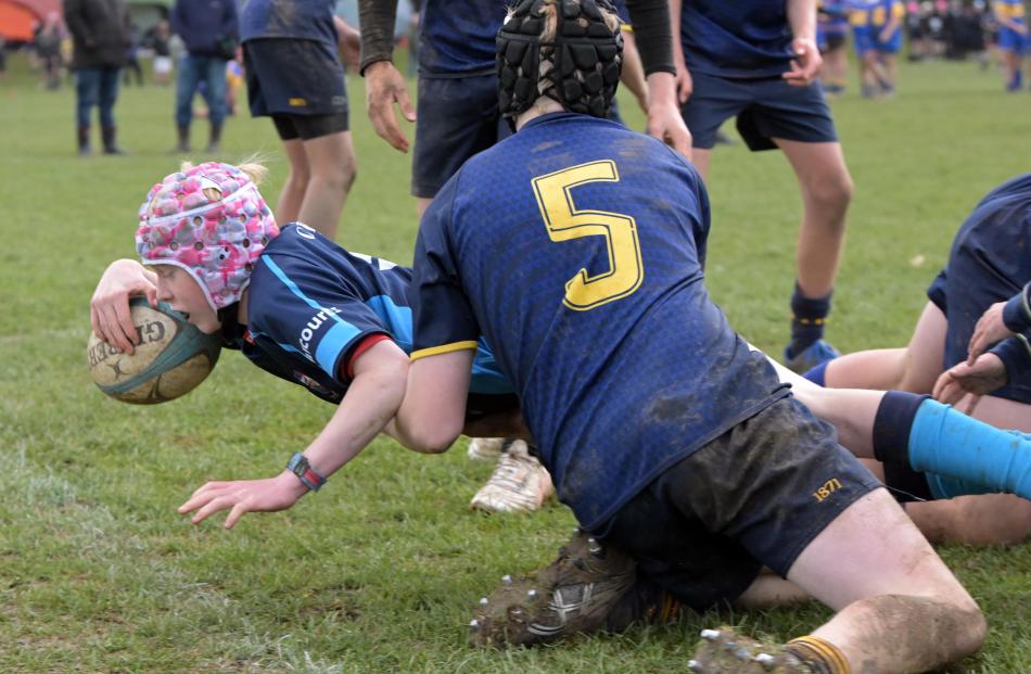 Wakatipu’s Jackson Kennedy, 13, dives across to score a try in the tackle of Dunedin’s Finn...