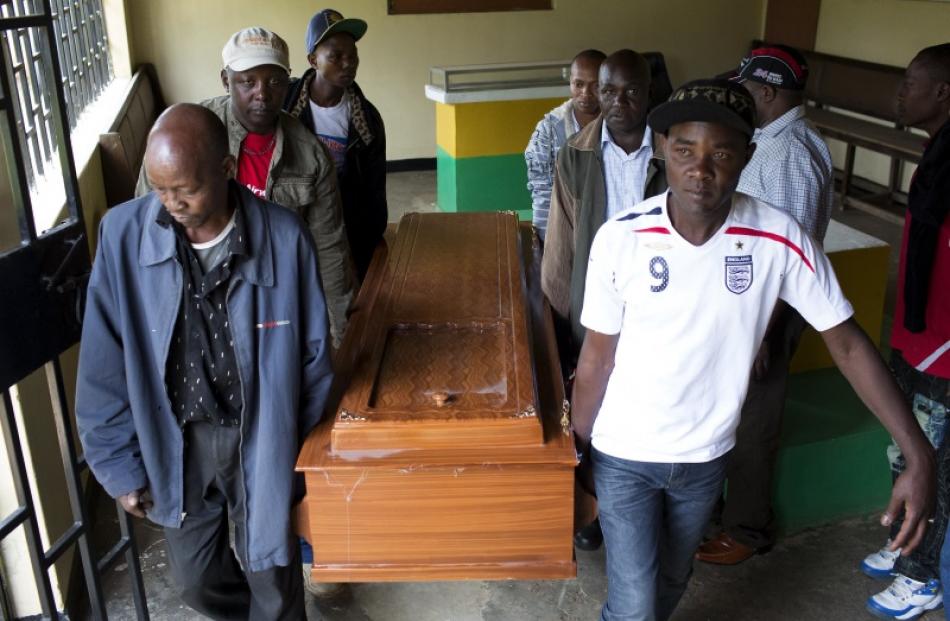 Family members and friends carry the coffin of Jackson Mutisya Mula. Relatives say the 28-year...