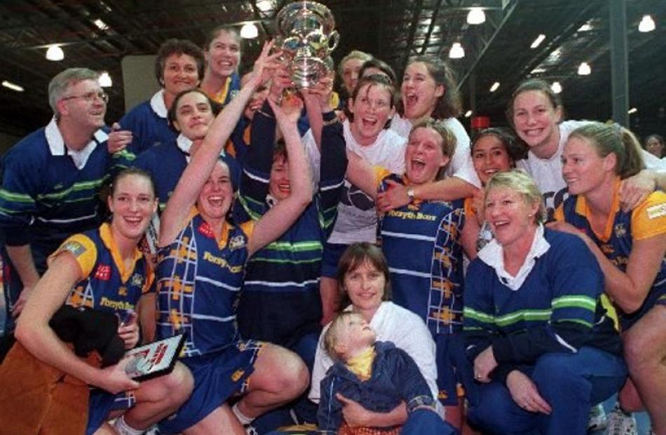 Sharon Kearney (centre) holds daughter Ala among the triumphant 1998 Rebels netball team.