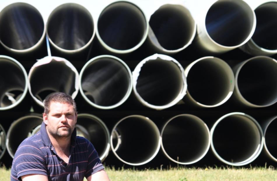 Kauru Hills deer farmer Dallas Newlands says  the pipes behind him, once in the ground, will...