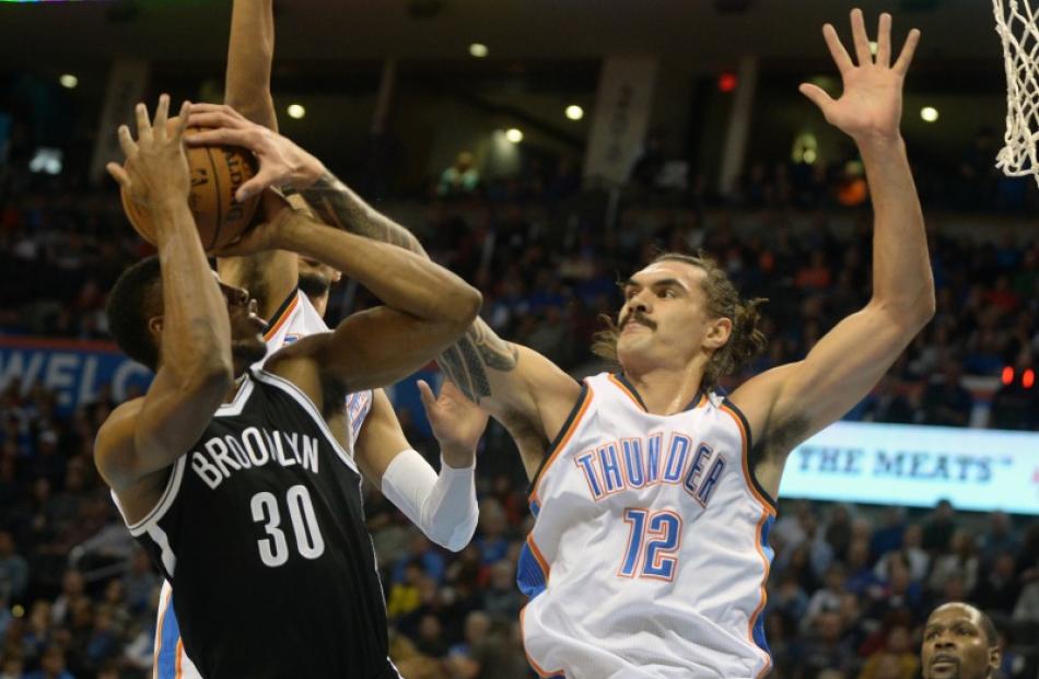 Kiwi basketballer Steven Adams, playing for the Oklahoma City Thunder, blocks Thaddeus Young of...