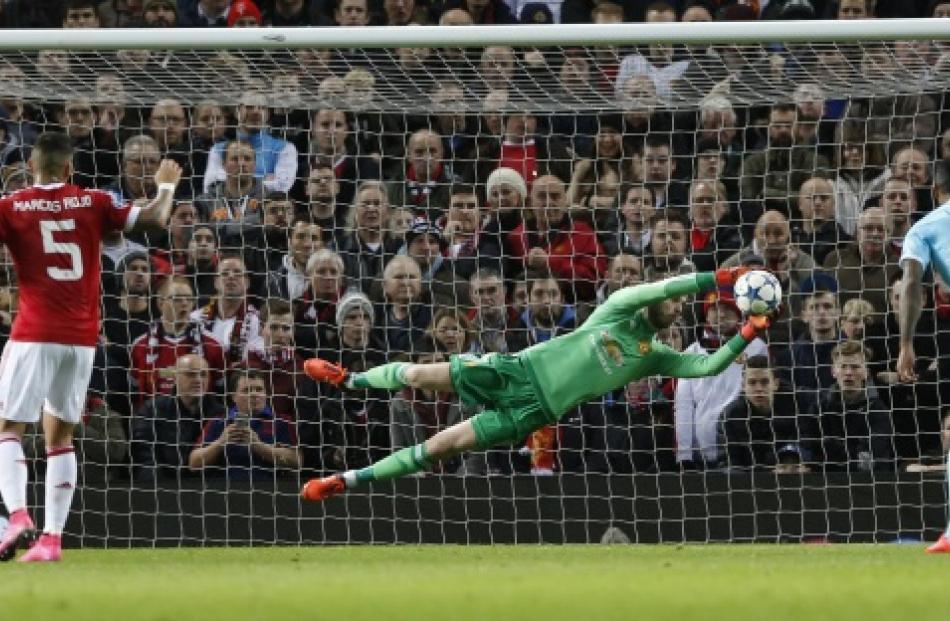 Manchester United goal keeper David De Gea dives to make a save during their Champions League...