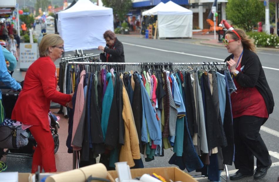 Shop on Taieri volunteers Lynley MacArthur (left) and Donna Knox rush a rack of clothes under...