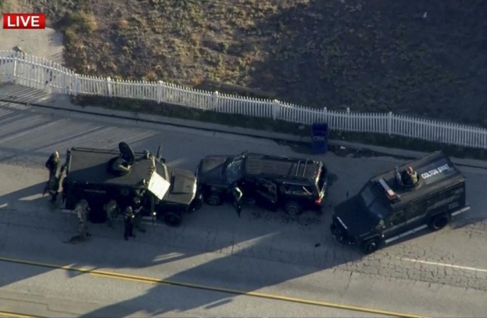 Police armoured cars close in on a suspect vehicle following the incident.