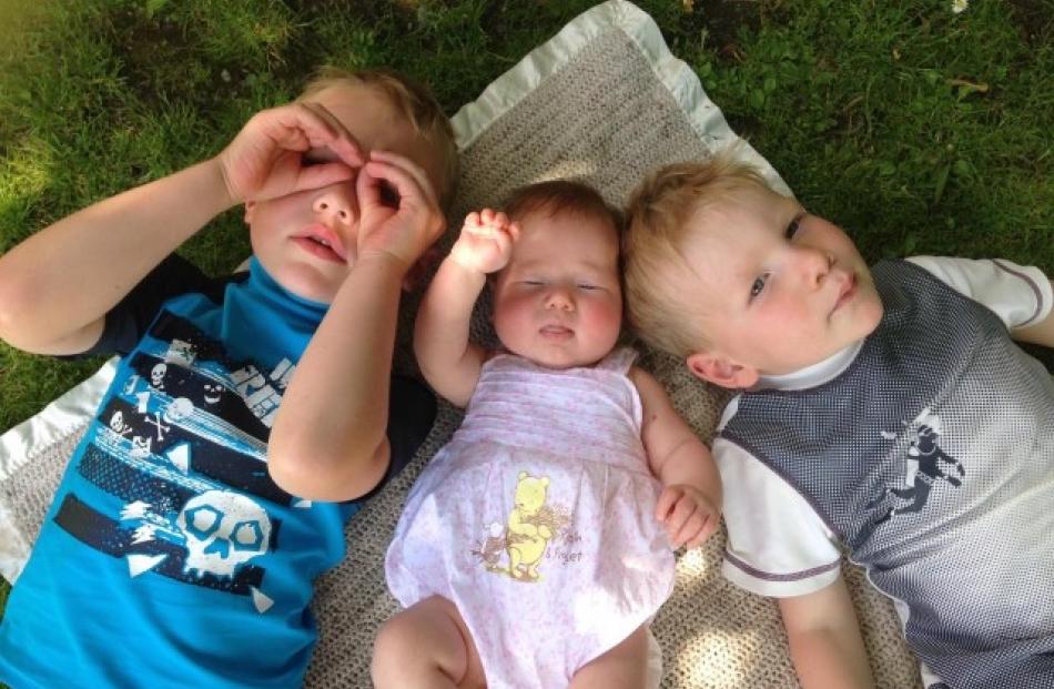 Cooling off in the shade are (l-r) Conan Tabb (5), Dakota Tabb (14 weeks), Riker Tabb (3). Photo...