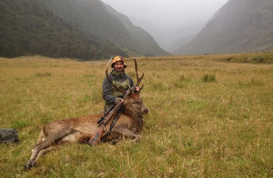 David Rider, of Queenstown, with a red stag in the Greenstone Valley. Photo supplied.