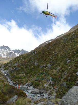 Doc staffer Bea Bayly prepares a load to be taken into the Rees-Dart Track.  Each year, the Doc...