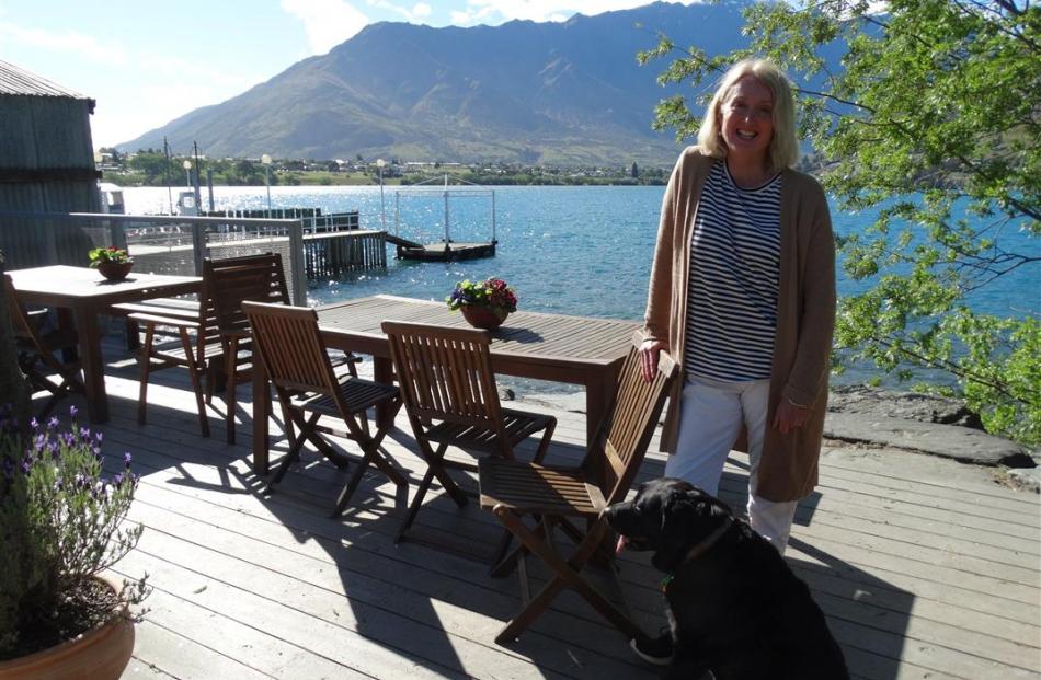 The Boatshed Cafe & Bistro owner Jane Shaw, with her dog Bella, on the deck of the Frankton...