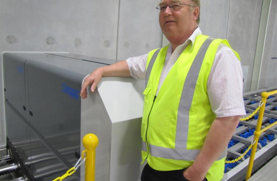 Cherrypac co-owner Henry van der Velden next to a ‘‘state-of-the-art’’ machine which takes 72...
