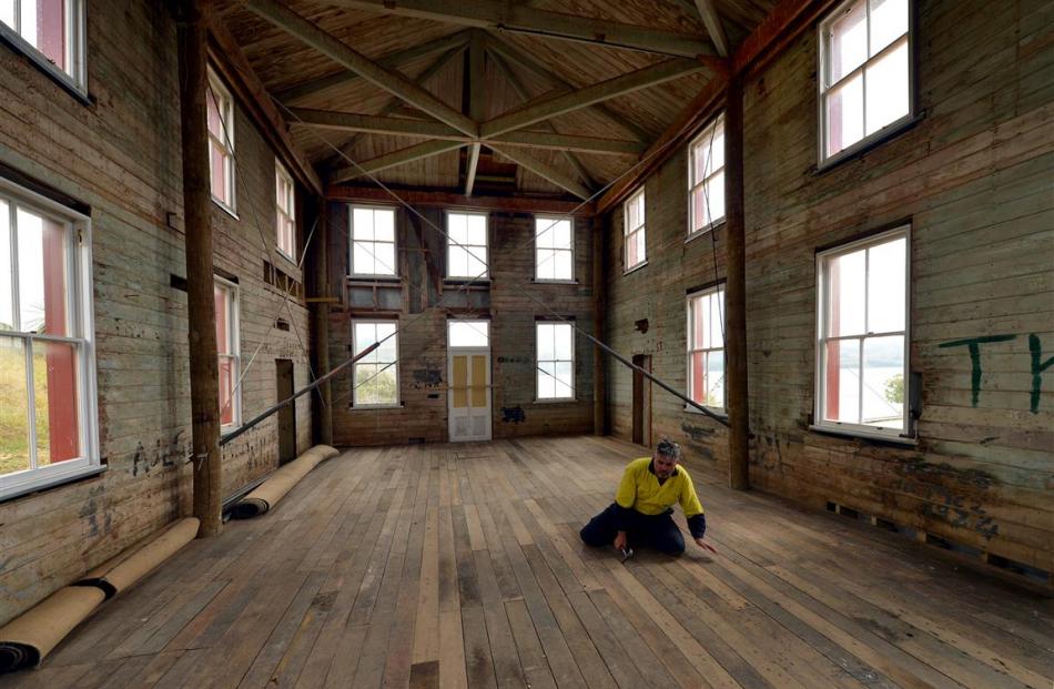 Volunteer Steve O’Connor, of Dunedin, nails down floorboards in the married quarters.