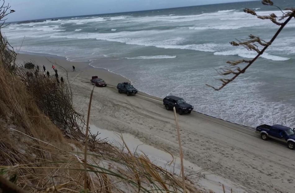 A car is towed from the beach on Sunday.