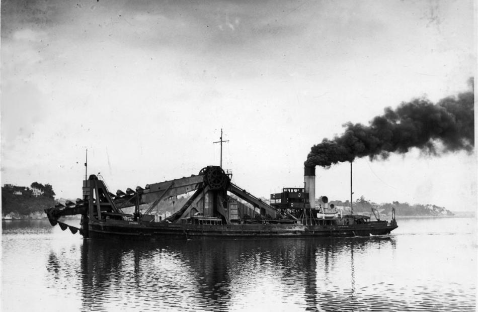 The Otago Harbour Board bucket dredge Otakou leaves the harbour steamer basin mid-last century....