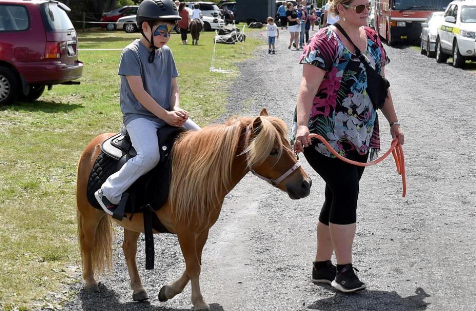 David Lander (7) rides Shetland pony Willy at the Brighton Gala. She is being led by Rowan Newman.