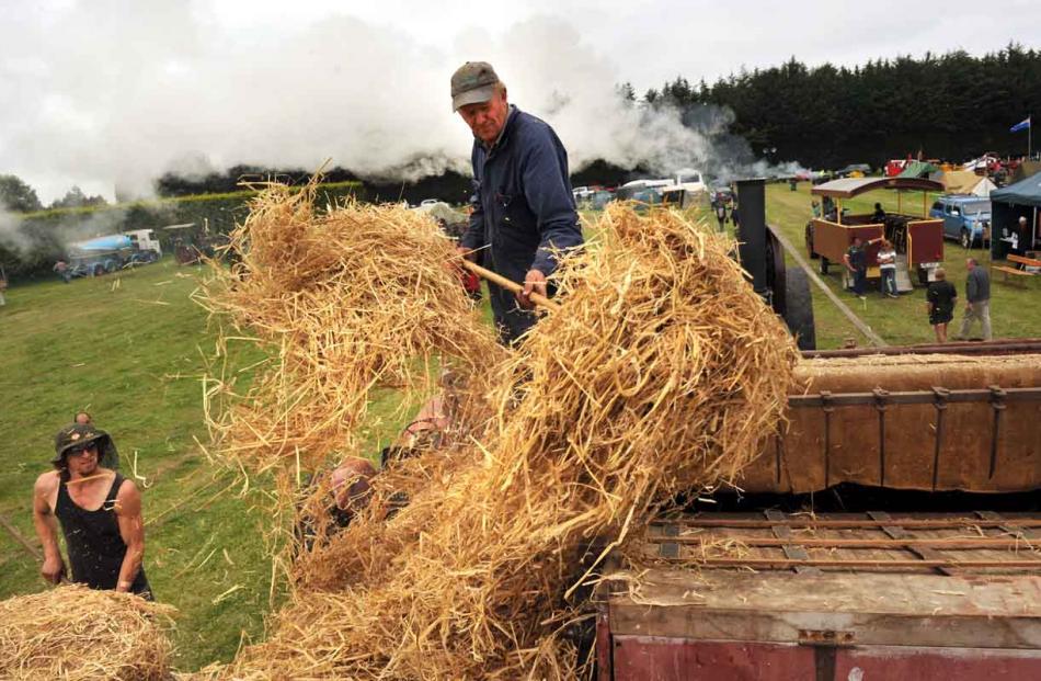 Quinton Scandrett (left) of Invercargill does some thrashing (throwing the grass) to Callum...