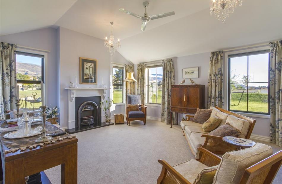 The sitting room has a vaulted ceiling and French doors connecting to a courtyard.