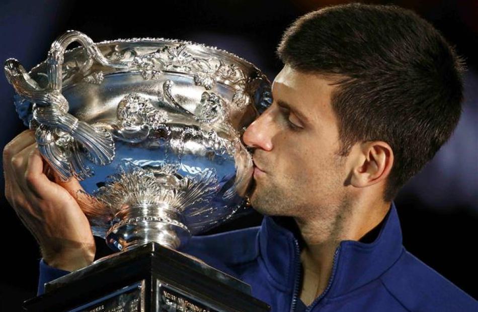 Novak Djokovic kisses the trophy after winning the Australian Open. Photo: Reuters
