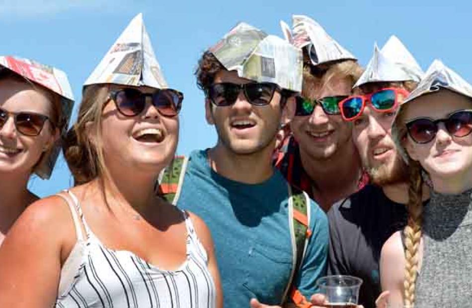 Sporting newspaper hats are (from left) Anna Pasco, from England, Laura Anderson, Australia,...