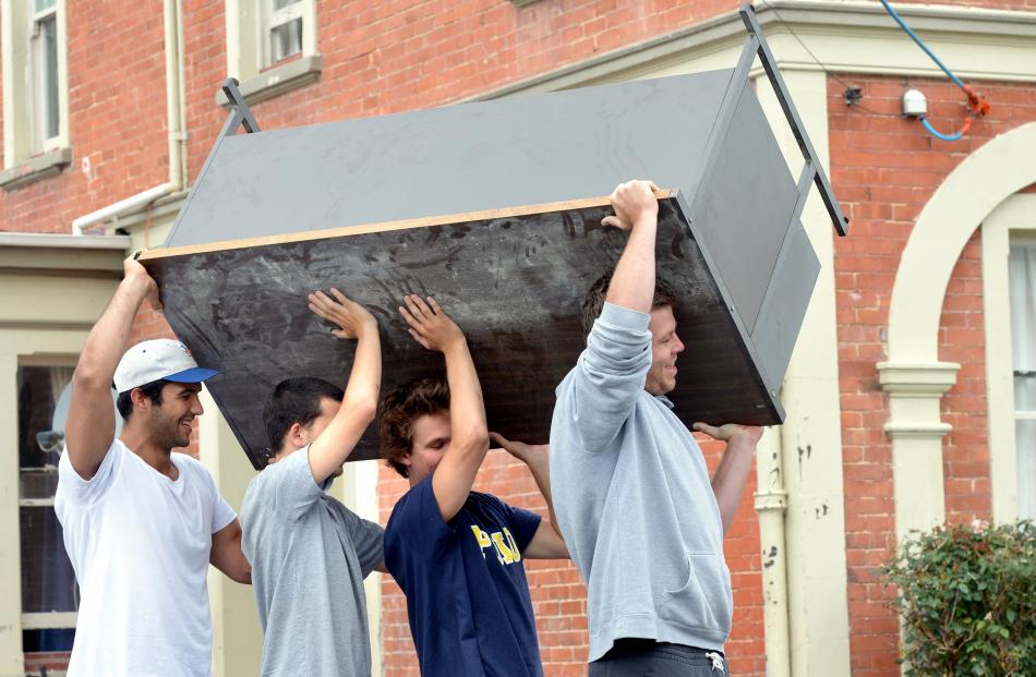 Carrying a table in Castle St are (from front) Teague McElroy (18), Roby Eady (19), both of...