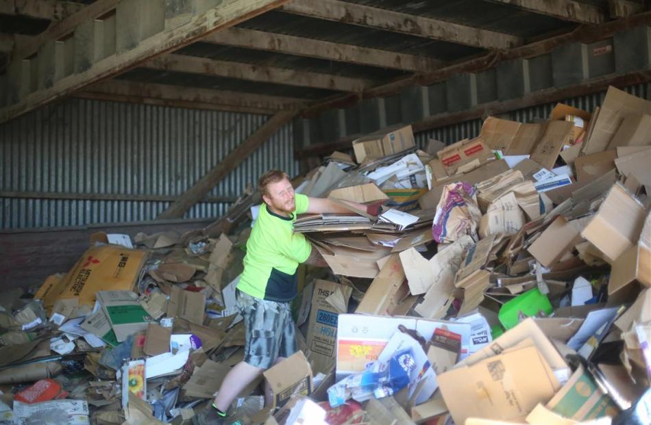 Waitaki Resource Recovery Park volunteer Paul Addison bales cardboard.