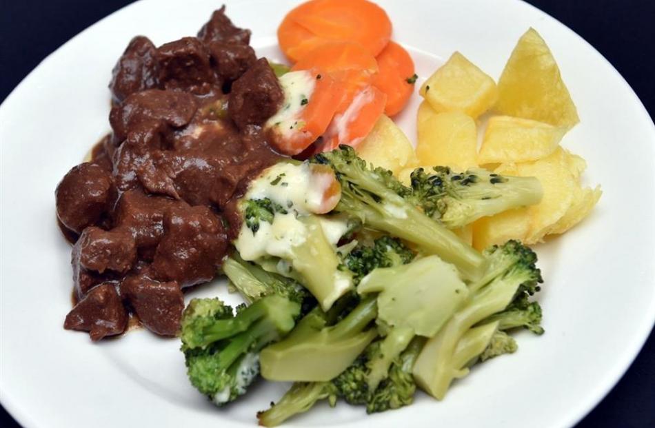 Barbecue beef with potatoes, carrots, broccoli and parsley sauce.
