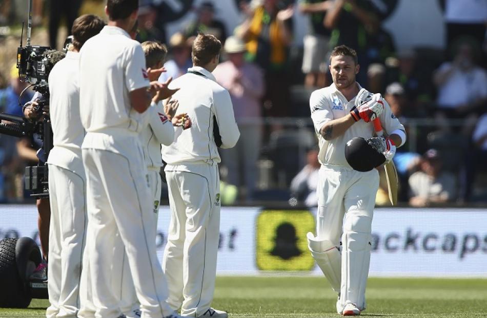 Australian players form a guard of honour as Brendon McCullum walks out to bat in his final test....