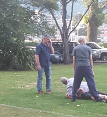 A man is subdued by university staff. Photo:
David Loughrey
