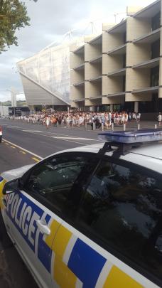 Police keep an eye on partygoers outside Forsyth Barr Stadium. Photo: David Loughrey