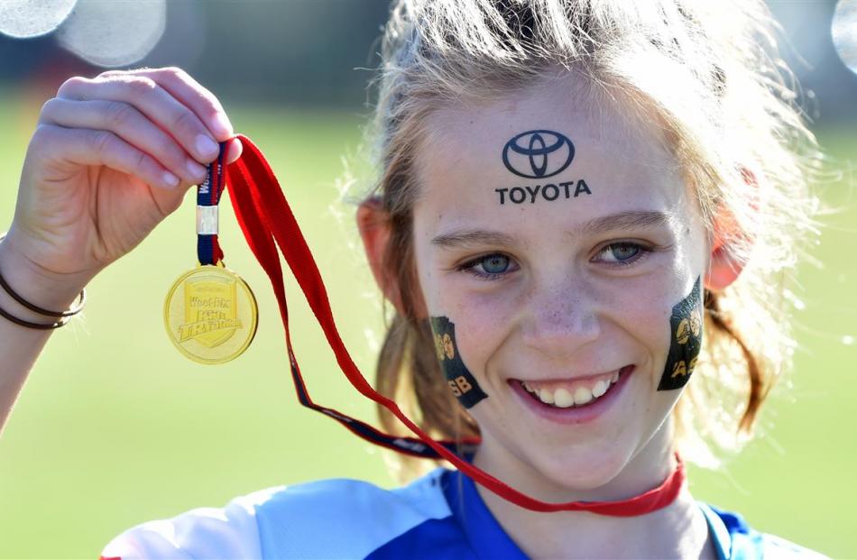 Libby Young (8), of Heriot, displays her TRYathlon medal.