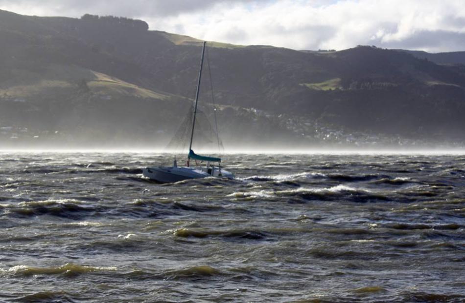 A yacht is tossed in waves caused by high winds at Macandrew Bay. Facebook/Macandrew Bay...
