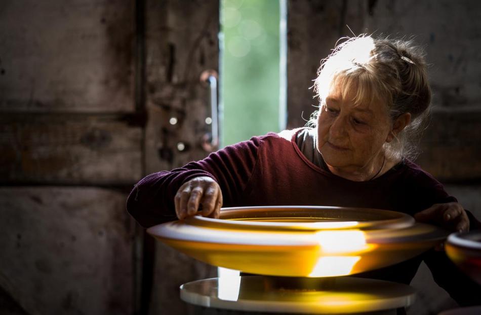 World-renowned glass artist Ann Robinson with  one of her pieces in her studio in Henderson,...