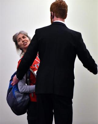 Protester Rosemary Penwarden is ushered out of the Trans Pacific Partnership Roadshow in Dunedin...