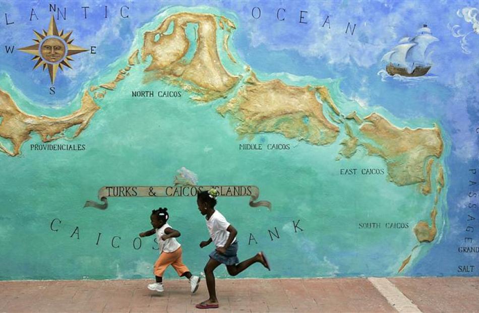 Two girls race past a mural.