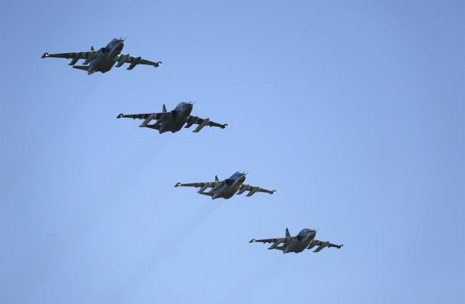Russian Sukhoi Su-25 fighter jets fly in formation after returning from Syria, before landing at...