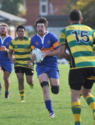 Taieri loose forward Brodie Hume looks to beat Green Island fullback Sam Eripea in a match at...