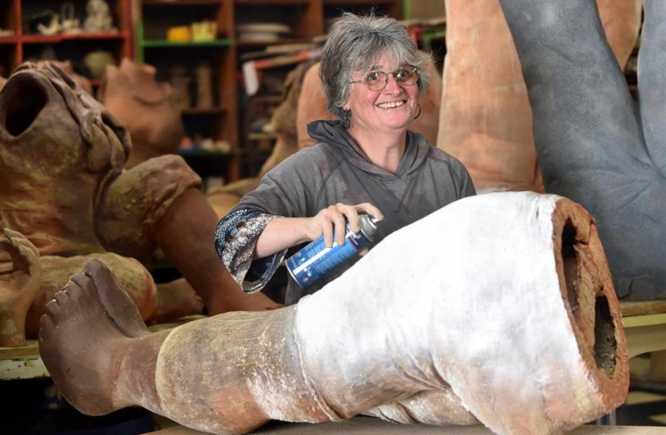 Suzanne Emslie works on one of her supersized clay figures.