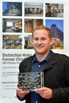 Matt Sloper, of Opus Architecture, holds an award for the transformation of Dunedin’s former...