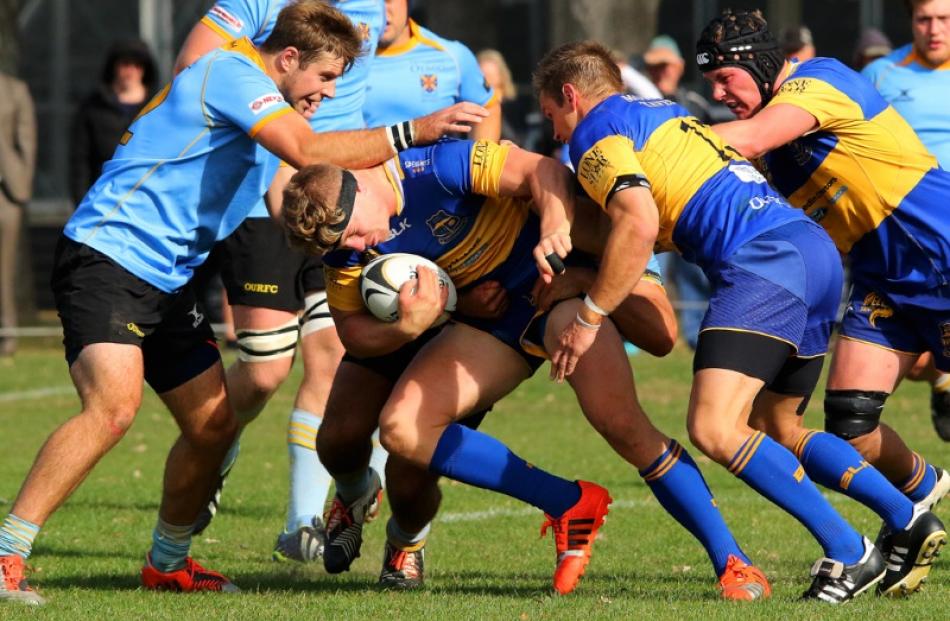 Taieri flanker James Lentjes drives the ball forward as teammates arrive in support to continue...
