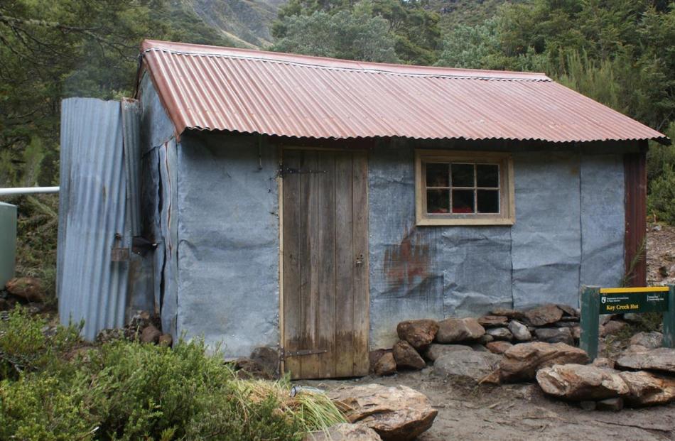 The renovated hut, with new door, new windows and water tank.