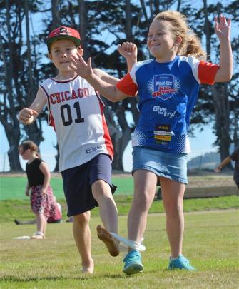Lachie Diack (8) and Grace James (7), both of Green Island, compete in the three-legged race.