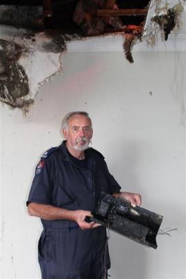 Fire investigator Mike Cahill holds one of the neon light transformers which he believes may have...