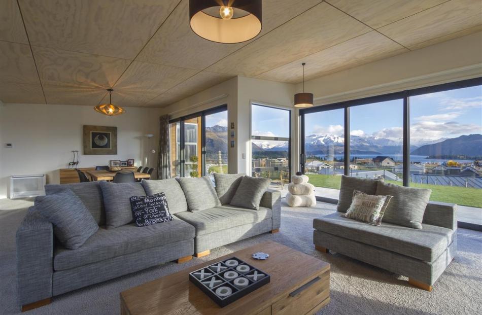 The living and dining area in this Wanaka home has unobstructed views to the north over Lake Wanaka.