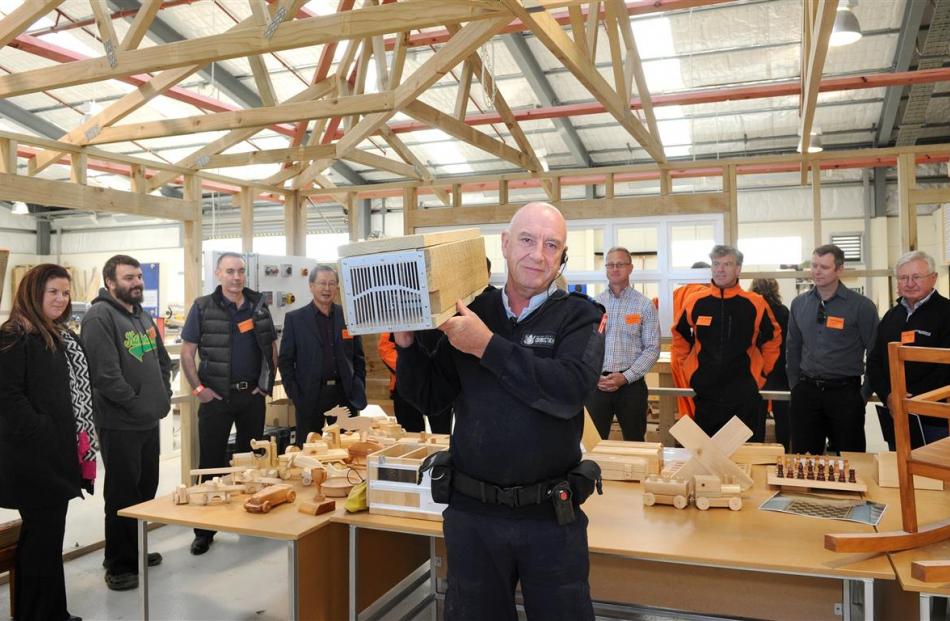 Otago Corrections Facility carpentry instructor Mark O’Kane holds a stoat trap made at the prison...