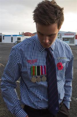 Mitchell Hollows wears his great-grandfather's medals yesterday.