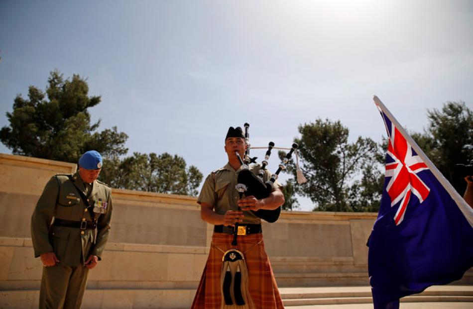 A soldier plays the bagpipes at the Commonwealth War Graves Cemetery in Jerusalem. Photo: Reuters
