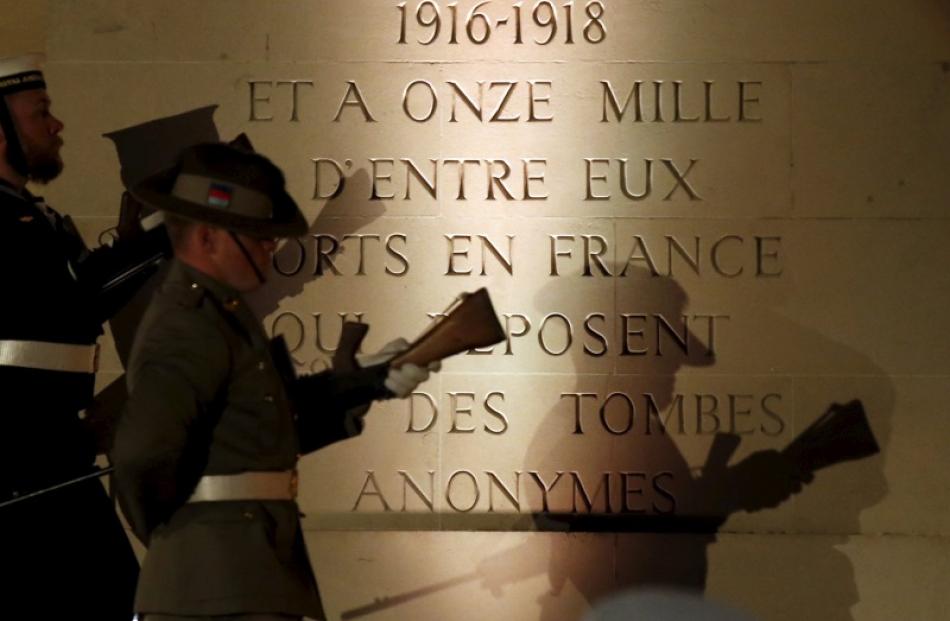The shadows of an Australian soldier are cast on a monument to the fallen in Villers-Bretonneux....